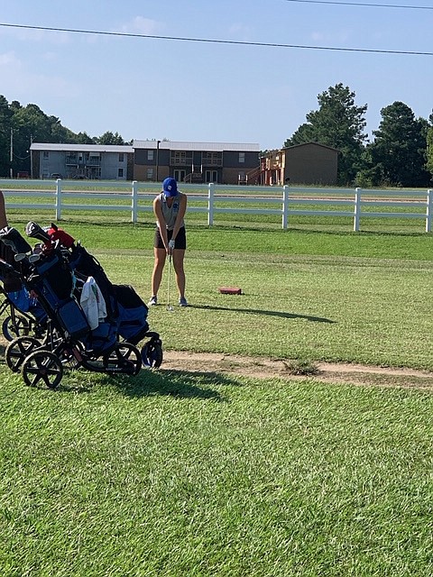 Co-medalist Hannah Collie tees off in Tuesday's 9-hole match against Camden Harmony Grove at Highland Golf Course in East Camden. Collie and Anna Cain shared the medalist honors with rounds of 38. - Photo submitted story.lead_photo.caption
