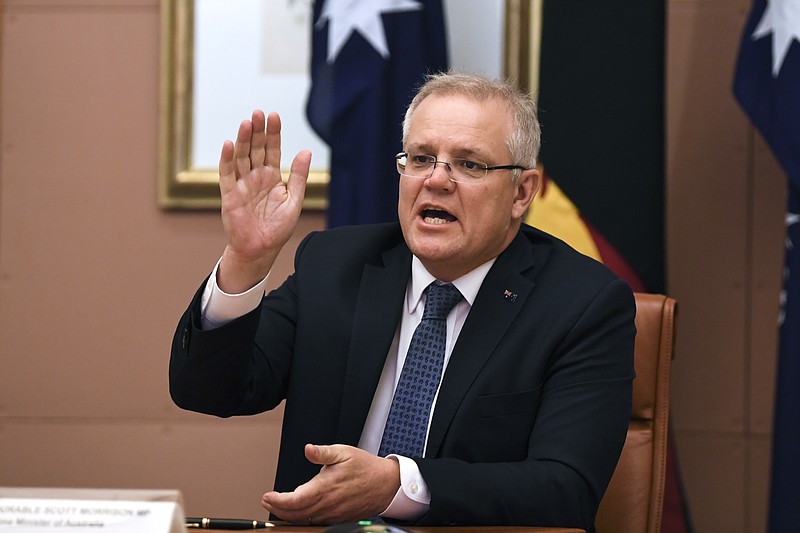Australian Prime Minister Scott Morrison speaks during a virtual summit meeting with Papua New Guinea's Prime Minister James Marape　at Parliament House in Canberra, Wednesday, Aug. 5, 2020. Morrison said on Wednesday, Aug. 5, 2020 his government held a less dramatic view of U.S.-China strategic tensions than a predecessor who warned of a potential “hot war” before U.S. presidential elections in November. (Lukas Coch/AAP Image via AP)