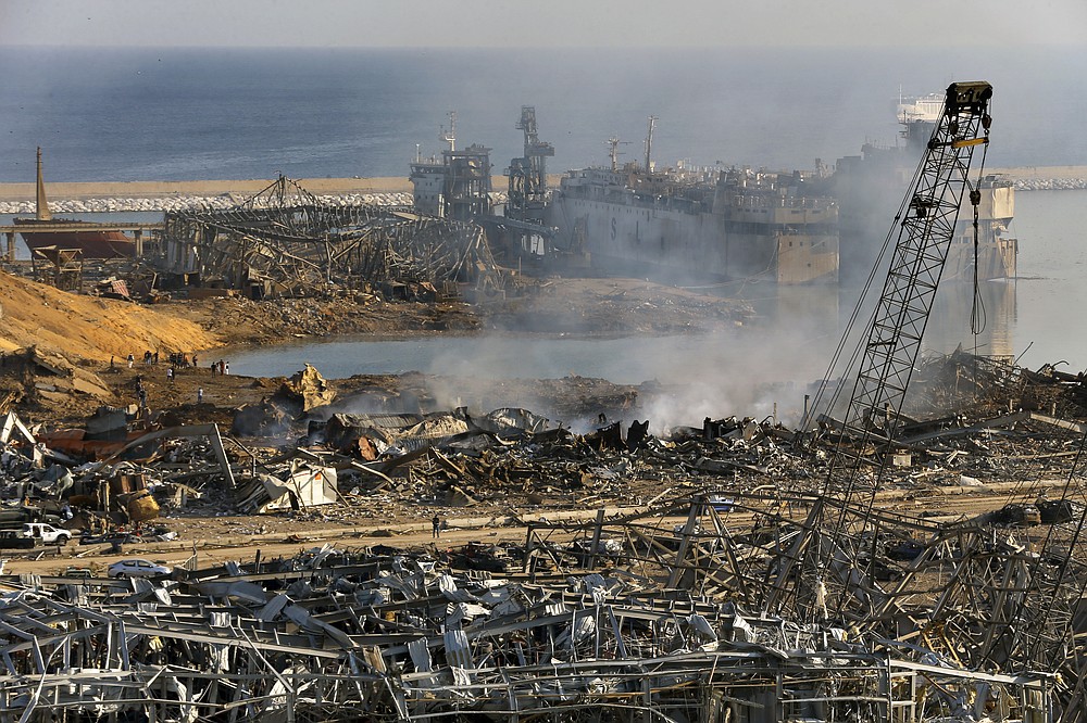 This photo shows a general view of the scene of an explosion that hit the seaport of Beirut, Lebanon, Wednesday, Aug. 5, 2020. The massive explosion rocked Beirut on Tuesday, flattening much of the city's port, damaging buildings across the capital and sending a giant mushroom cloud into the sky. (AP Photo/Bilal Hussein)