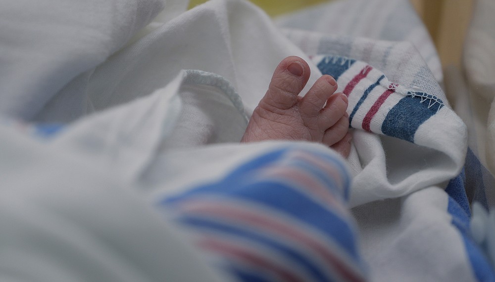 The toes of a baby born to a mom with COVID-19 are seen at DHR Health, Wednesday, July 29, 2020, in McAllen, Texas. The hospital lets COVID-positive mothers call the nursery over a video chat. (AP Photo/Eric Gay)