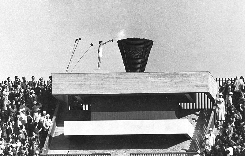 Japanese runner Yoshinori Sakai lights the Olympic cauldron on Oct. 10, 1964, during the opening ceremony of the 1964 Summer Olympics in Tokyo. He symbolized the rebirth of Japan after the Second World War as he opened the 1964 Tokyo Games. Sakai was born in Hiroshima on Aug. 6, 1945, the day the United States dropped an atomic bomb on the city.  Just over 19 years later, he ran with the Olympic flame into the national stadium, left the cinder track, and jogged up a long flight of flower-lined stairs to reach the top. - The Associated Press file photo