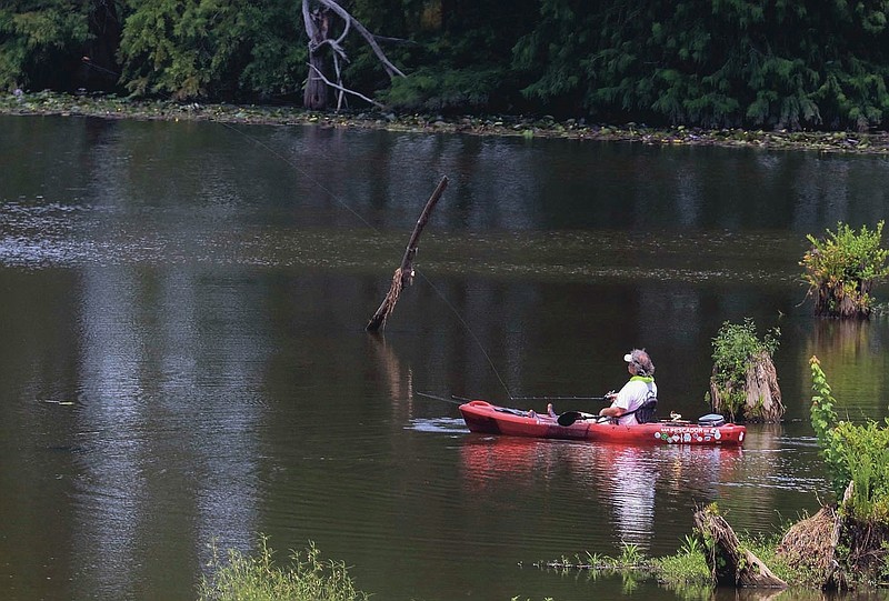 A fisherman casts his line into the water Tuesday Aug. 4, 2020 in Little Rock while fishing on the Little Maumelle River. (Arkansas Democrat-Gazette/Staton Breidenthal)