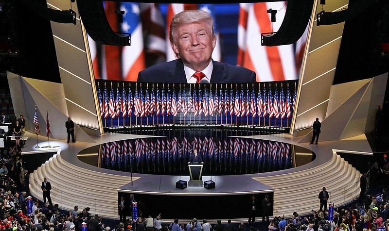 FILE - In this July 21, 2016, file photo, Republican presidential candidate Donald Trump smiles as he addresses delegates during the final day session of the Republican National Convention in Cleveland. North Carolina public health officials told the Republican National Committee the party can have more than 10 people in a room to conduct official convention business while in Charlotte. The updated guidance eases indoor gathering limits Democratic Gov. Roy Cooper imposed in a recently extended executive order. (AP Photo/Patrick Semansky, File)