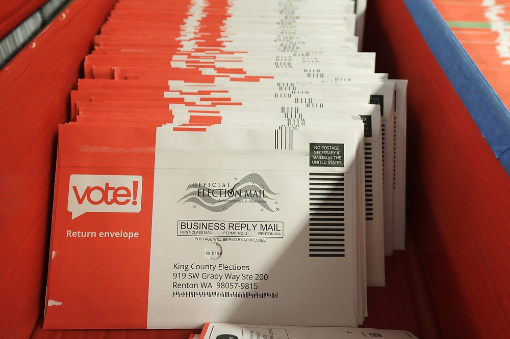 Vote-by-mail ballots are shown in a sorting tray, Wednesday, Aug. 5, 2020, at the King County Elections headquarters in Renton, Wash., south of Seattle. Never in U.S. history will so many people exercise the right on which their democracy hinges by marking a ballot at home. (AP Photo/Ted S. Warren)