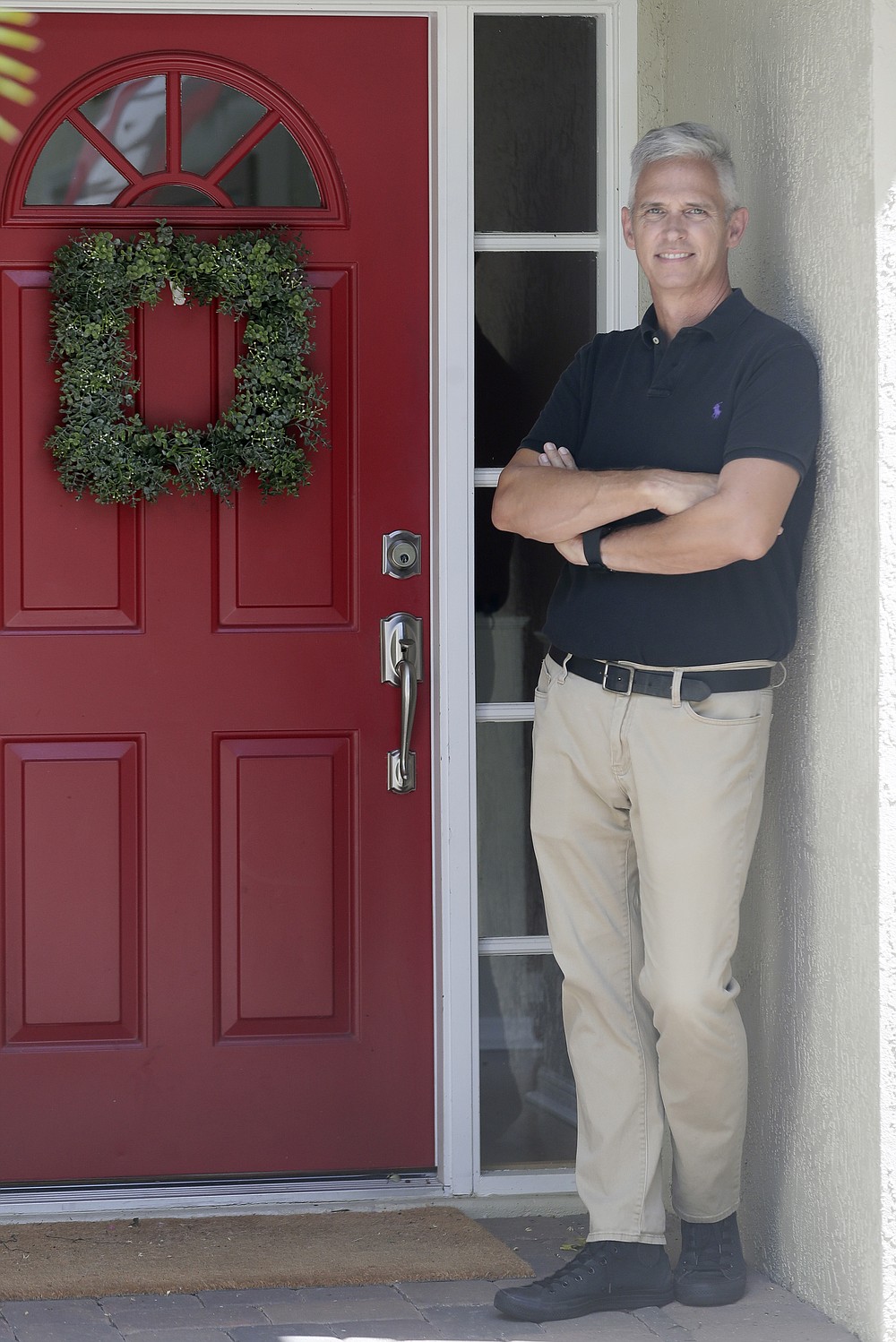 Bob Garick stands by the entrance to his home Wednesday, Aug. 5, 2020, in Oviedo, Fla. Garick was looking forward to being a field supervisor during the door-knocking phase of the 2020 census, but as the number of new coronavirus cases in Florida shot up last month, he changed his mind and decided not to take the job. (AP Photo/John Raoux)