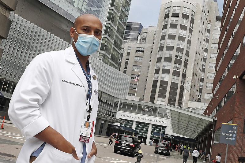 Alister Martin, an emergency room doctor at Massachusetts General Hospital, poses outside the hospital, Friday, Aug. 7, 2020, in Boston. Martin founded the organization "VotER" to provide medical professionals voter registration resources for patients who are unregistered voters. (AP Photo/Charles Krupa)