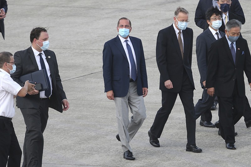 U.S. Health and Human Services Secretary Alex Azar, center, arrives at Taipei Songshan Airport in Taipei, Taiwan, Sunday, Aug. 9, 2020. Azar arrived in Taiwan on Sunday in the highest-level visit by an American Cabinet official since the break in formal diplomatic relations between Washington and Taipei in 1979. (AP Photo/Chiang Ying-ying)