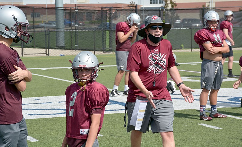 Graham Thomas/Herald-Leader
Siloam Springs defensive coordinator Cole Harriman gives safety instructions to Siloam Springs football players during practice Monday at Panther Stadium.