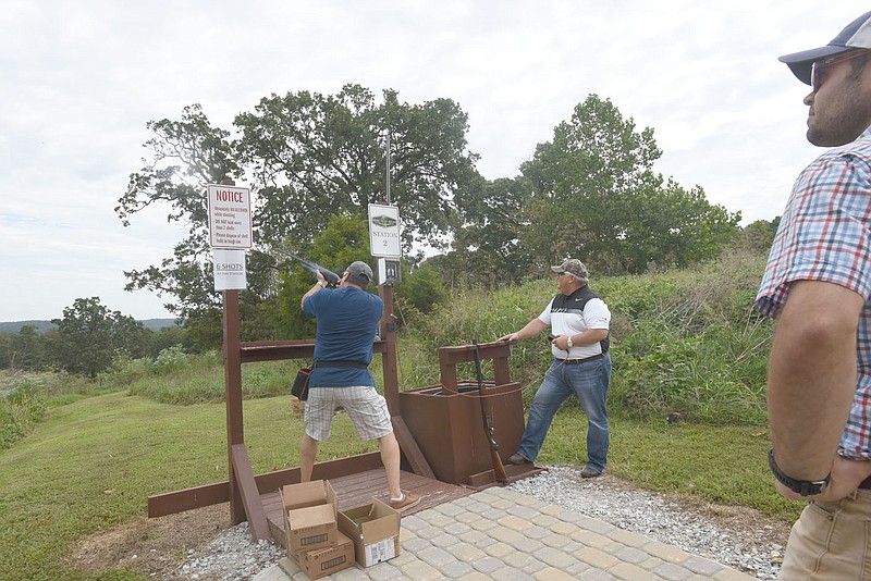 NWA Democrat-Gazette/FLIP PUTTHOFF
ON TARGET
Adonai Leiva of Joplin, Mo. shoots a clay target Saturday Aug. 26 2017 launched by Kevin Lyles of Bentonville (second from left) during the annual AIM for Advocacy sporting clays tournament held at Spring Valley Anglers Rod and Gun Club near Decatur. The event raised funds for Restoration Village. Retoration Village in Little Flock provides a safe environment for women and children in a crisis time of their lives. Money raised at the sporting clays event supports services to clients, said Tara Lentz, a counselor at Restoration Village. Sporting clays is a shotgun shooting game where clay targets fly in ways that simuate various hunting situations.