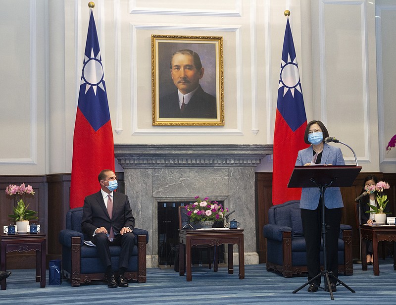 U.S. Health and Human Services Secretary Alex Azar, left, listens as Taiwan's President Tsai Ing-wen speaks during a meeting in Taipei, Taiwan Monday, Aug. 10, 2020. Azar met with Tsai on Monday during the highest-level visit by an American Cabinet official since the break in formal diplomatic ties between Washington and Taipei in 1979.  (Pool Photo via AP Photo)