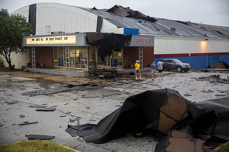 Pieces of the Buccaneer Arena roof litter the parking lot after a strong thunderstorm with high winds blew through the Des Moines metro on Monday, Aug. 10. 2020, in Urbandale, Iowa. (Kelsey Kremer/The Des Moines Register via AP)