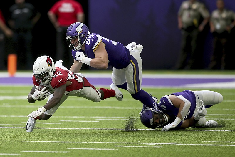 FILE - In this Aug. 24, 2019, file photo, Arizona Cardinals running back T.J. Logan (22) runs from Minnesota Vikings linebacker Cameron Smith (59) during the second half of an NFL preseason football game in Minneapolis. Smith will miss the 2020 season because of a heart condition. It was discovered after he tested positive for COVID-19 upon reporting to training camp two weeks ago. The Vikings made the procedural move on Monday, Aug. 10, 2020, of waiving Smith with a non-football injury designation. (AP Photo/Jim Mone, File)