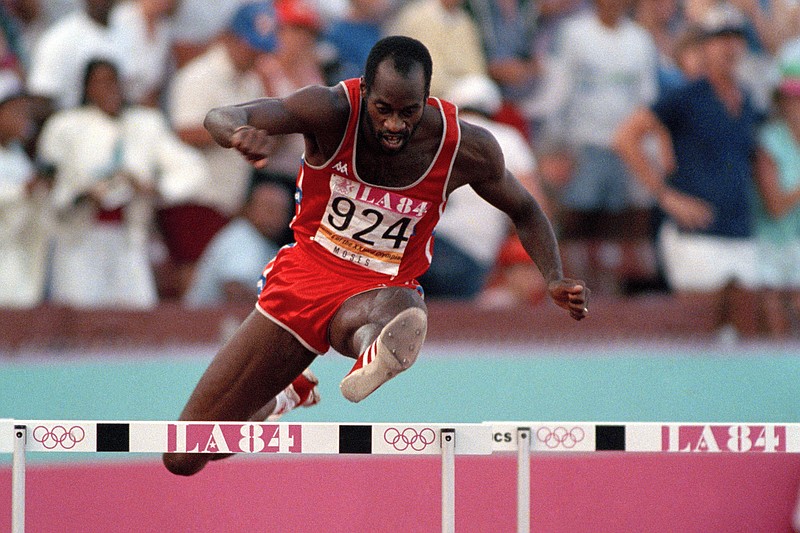 United States' Edwin Moses jumps a hurdle on his way to winning the gold medal in the 400-meter hurdles at the Summer Olympic Games in Los Angeles on Aug. 5, 1984. - The Associated Press file photo