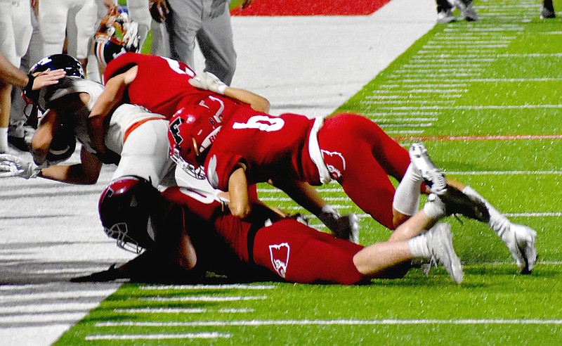 MARK HUMPHREY  ENTERPRISE-LEADER/A trio of Farmington defenders knock a pass receiver out-of-bounds. The Cardinal defense stopped Valley View twice on goal-line stands in the fourth quarter of Friday's 28-7 win, Farmington first postseason victory since becoming a 5A school.
