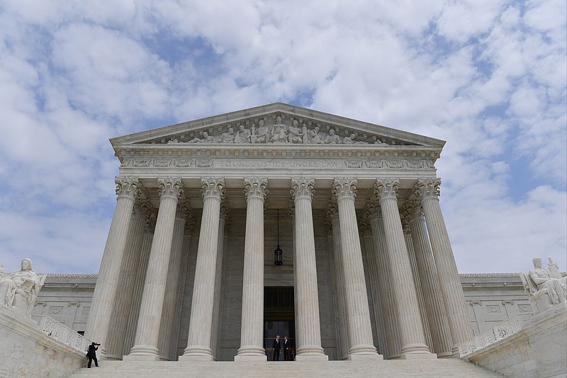 Associate Justice Neil Gorsuch, left, and Chief Justice John Roberts walk to the steps of the U.S. Supreme Court on June 15, 2017 in Washington. MUST CREDIT: Washington Post photo by Ricky Carioti