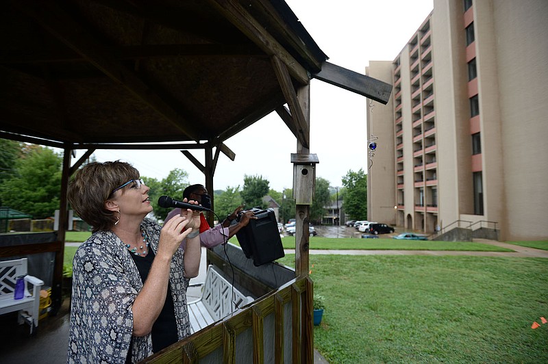 Angela Belford, executive director of the Fayetteville Housing Authority, speaks Friday, Aug. 7, 2020, into a microphone as she informs residents at Hillcrest Towers of an expansion project at the facility in downtown Fayetteville. The Fayetteville Housing Authority plans to expand Hillcrest Towers, the public housing complex downtown for seniors and disabled residents, with additional units. Visit nwaonline.com/200816Daily/ for today's photo gallery.
(NWA Democrat-Gazette/Andy Shupe)