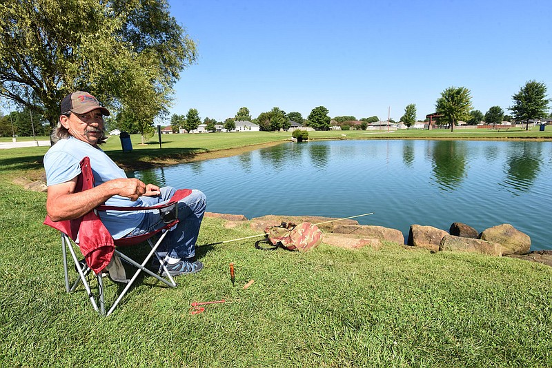 ANGLING FOR OLD WHISKERS
Roy Patterson of Springdale relaxes in a lawn chair while fishing on Wednesday at Ward Nail Park in Lowell. Patterson fished for catfish using chunks of hot dogs for bait. He'd caught five catfish by mid-morning on Wednesday. Go to nwaonline.com/200813Daily/ to see more photos. 
(NWA Democrat-Gazette/Flip Putthoff)