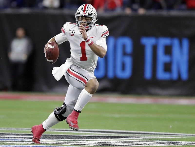 Ohio State quarterback Justin Fields (1) runs with the ball against Wisconsin during the first half of the Big Ten championship game in Indianapolis on Dec. 7, 2019. The Big Ten won’t play football this fall because of concerns about COVID-19, becoming the first of college sports’ power conferences to yield to the pandemic. The move announced Tuesday comes six day after the conference that includes historic programs such as Ohio State, Michigan, Nebraska and Penn State had released a revised conference-only schedule that it hoped would help it navigate a fall season with potential COVID-19 disruptions. - Photo by Michael Conroy of The Associated Press