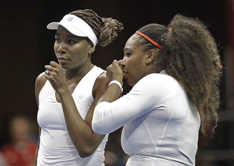 USA’s Venus Williams, left, and Serena Williams, right, talk between points in their Feb. 11, 2018, doubles match against Netherlands’ Leslie Herkhove and Demi Schuurs in the first round of the Fed Cup tennis competition in Asheville, N.C. The siblings meet each other for the 31st time when they take the court at a WTA tournament in Kentucky today. - Photo by Chuck Burton of The Associated Press