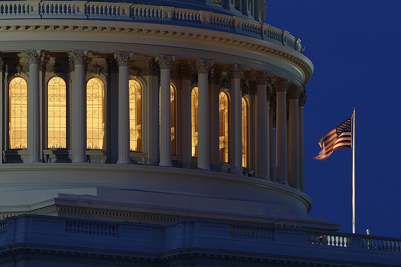 FILE - In this July 16, 2019, file photo an American flag flies on the Capitol Dome in Washington. The U.S. budget deficit climbed to $2.81 trillion in the first 10 months of the budget year, exceeding any on record, the Treasury Department said Wednesday, Aug. 12, 2020. (AP Photo/Carolyn Kaster, File)