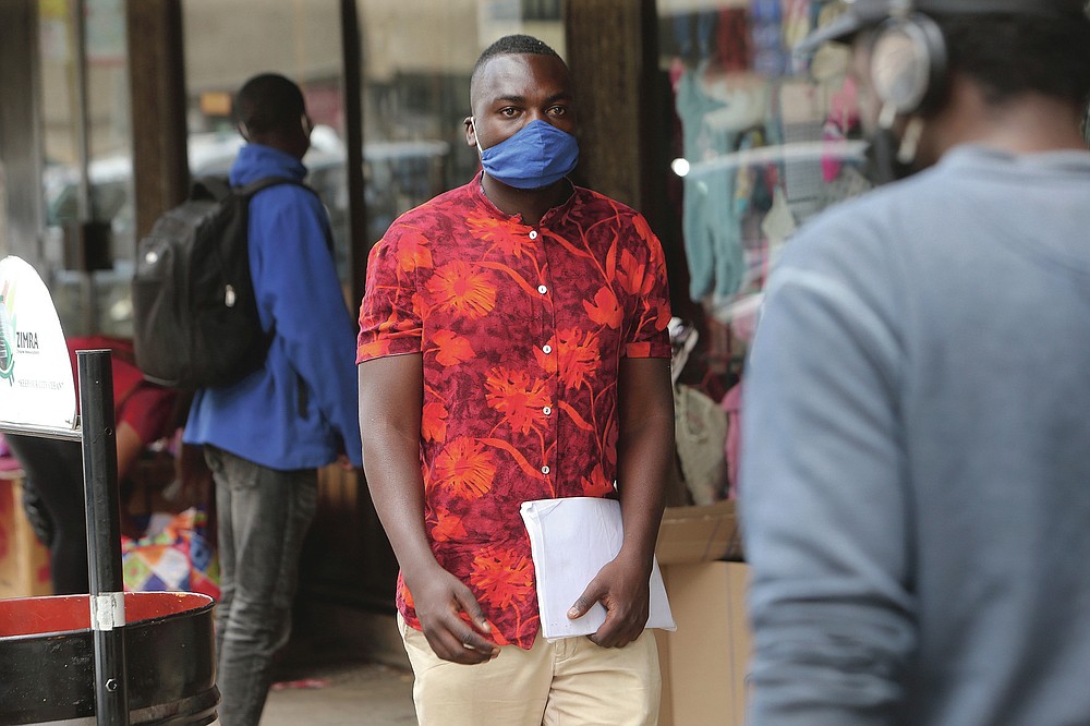 Emmanuel Reyai walks on the streets of Harare while looking for a job, Wednesday, Aug, 5, 2020. Around the world, young people armed with new degrees, diplomas and professional qualifications are struggling to enter the workforce as the pandemic pushes the global economy into recession. Two years after graduating with from Zimbabwe’s Midlands State University, 24-year old Emmanuel Reyai is no closer to his goal of getting a job related to his degree in local governance. His search is stymied by both the African country’s economic collapse and the coronavirus outbreak. (AP Photo/Tsvangirayi Mukwazhi)