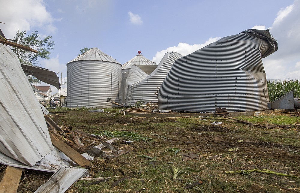 Residents begin cleaning up storm damage from dangerous straight-line winds and possible tornadoes caused by a rare derecho on Tuesday, Aug. 11, 2020, in Wakarusa, Ind. (Robert Franklin/South Bend Tribune via AP)