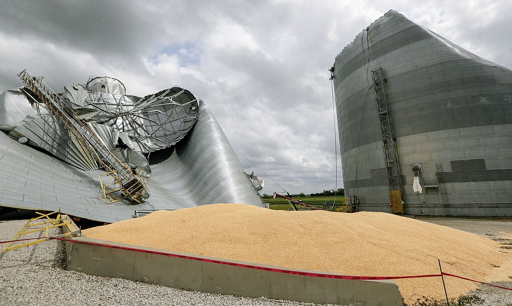 Grain bins are seen severely damaged on the Archer Daniels Midland facility in Keystone, Iowa, on Wednesday, Aug. 12, 2020. A storm slammed the Midwest with straight line winds of up to 100 miles per hour on Monday, gaining strength as it plowed through Iowa farm fields, flattening corn and bursting grain bins still filled with tens of millions of bushels of last year’s harvest. (Jim Slosiarek/The Gazette via AP)