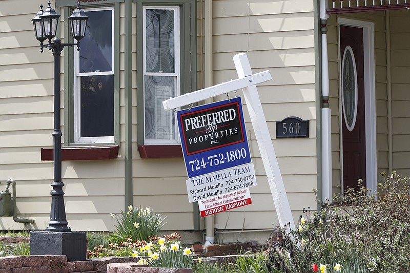 This April 16, 2020 file photo shows a real estate company sign that marks a home for sale in Harmony, Pa. (AP Photo/Keith Srakocic, File)