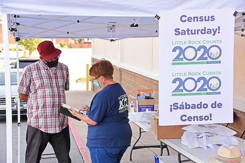 Volunteer Harriett Philips assists David Golden of Little Rock with filling out the 2020 census form during the Census Saturday event on Aug. 15, 2020, at Edwards Food Giant on Main Street in Little Rock. (Arkansas Democrat-Gazette/Staci Vandagriff)