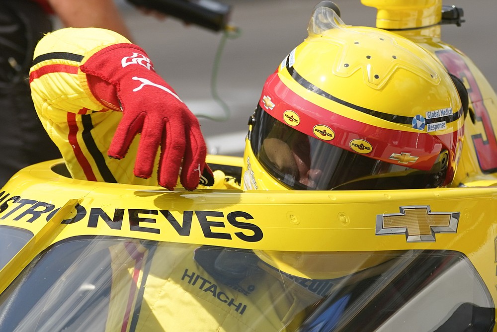 Helio Castroneves, of Brazil, climbs out of his car during qualifications for the Indianapolis 500 auto race at Indianapolis Motor Speedway, Saturday, Aug. 15, 2020, in Indianapolis. (AP Photo/Darron Cummings)