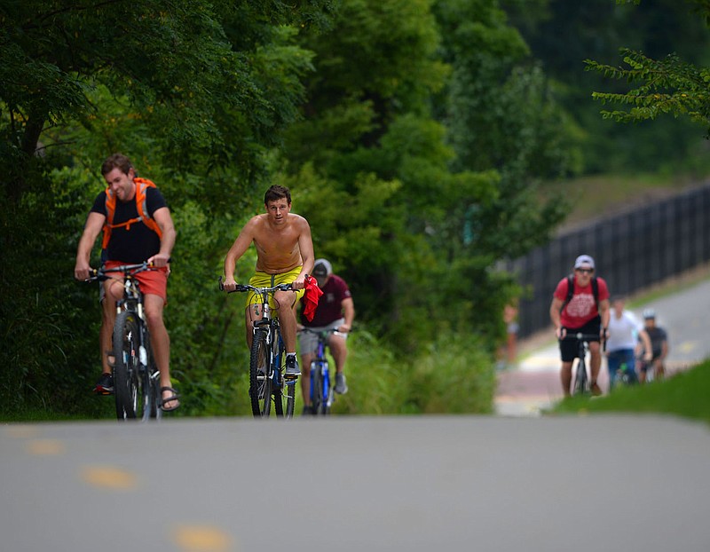 Riders make their way south Saturday, Aug. 8, 2020, on the Frisco Trail north of Maple Street in Fayetteville. The Walton Family Foundation released its 2019 trail usage report, the third one since 2019, which finds that the trail systems in Northwest Arkansas are experiencing a steady rise in bike and foot traffic. Visit nwaonline.com/200816Daily/ for today's photo gallery.
(NWA Democrat-Gazette/Andy Shupe)