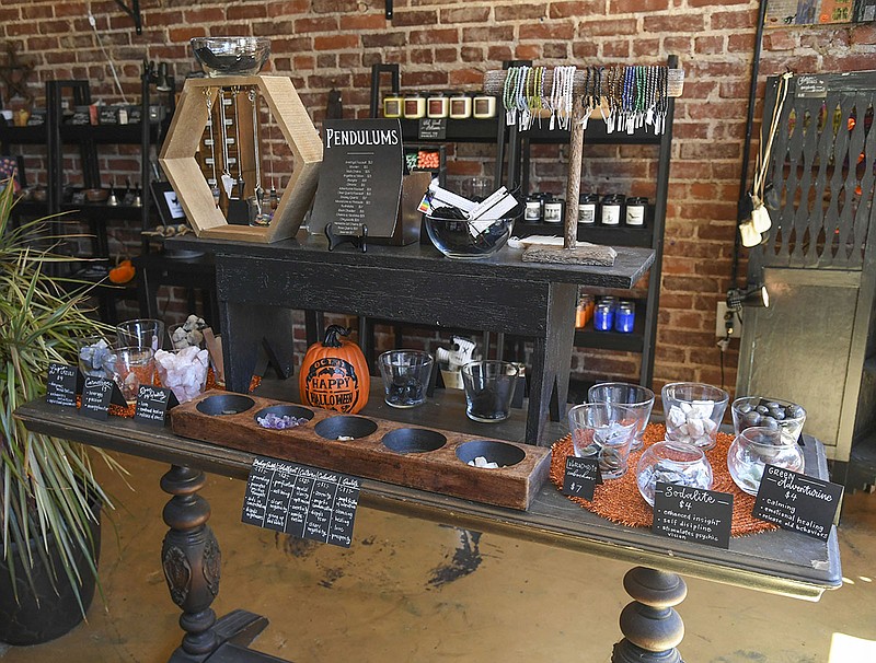 A table displaying pendulums and crystals is shown inside the Parlour on Aug. 19. -Photo by Grace Brown of The Sentinel-Record