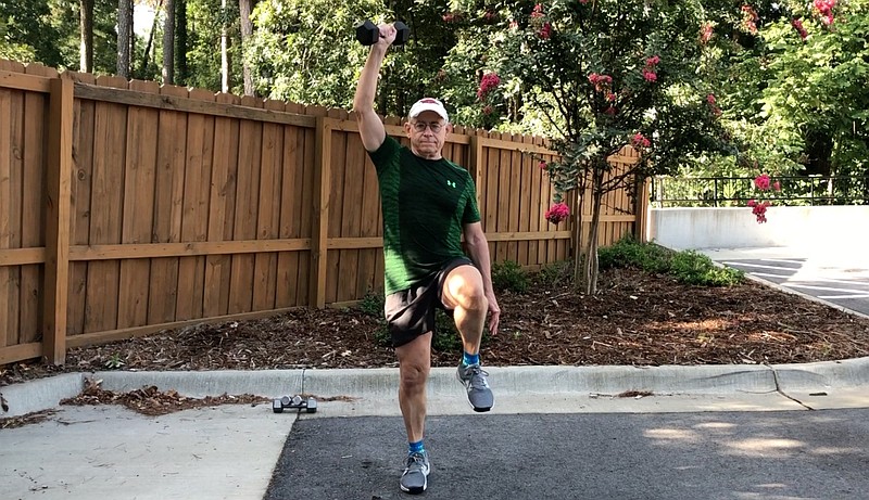 Eddie Dunn demonstrates the Quadruped Raise outside Little Rock Racquet Club. (Arkansas Democrat-Gazette/Celia Storey)