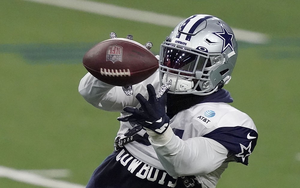 Dallas Cowboys helmets sit on the field during an NFL training camp football  practice in Frisco …