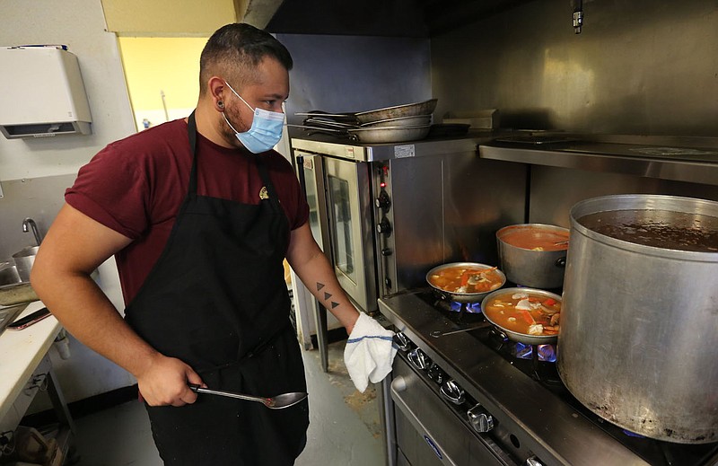 Edmundo Alvarez, co-owner and cook at Mariscos Playa Azul Mexican Seafood and Grill, prepares a Caldo de Siete Mares Wednesday, August 26, 2020, in the kitchen of the restaurant in Springdale. Check out nwaonline.com/200830Daily/ and nwadg.com/photos for a photo gallery.
(NWA Democrat-Gazette/David Gottschalk)