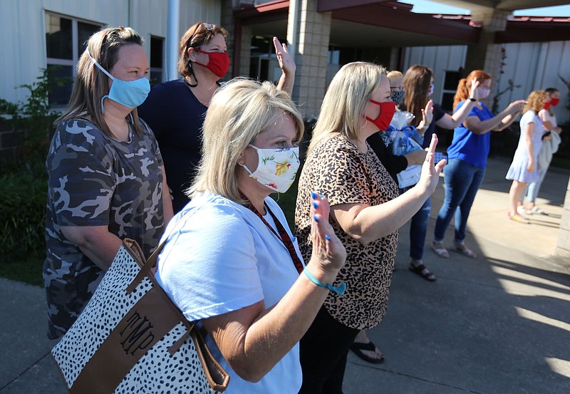 Teachers at Jerry "Pop" Williams Elementary School wave Wednesday, August 19, 2020, during the Fayetteville Chamber of Commerce Teacher's Appreciation Parade at the school in Farmington. The chamber stopped at three to four schools in Farmington, Prairie Grove, Lincoln and West Fork where they donated items including, 2,000 masks to each school, and played a video of appreciation on the Lewis Automotive Video Billboard. Check out nwaonline.com/200820Daily/ and nwadg.com/photos for a photo gallery.
(NWA Democrat-Gazette/David Gottschalk)