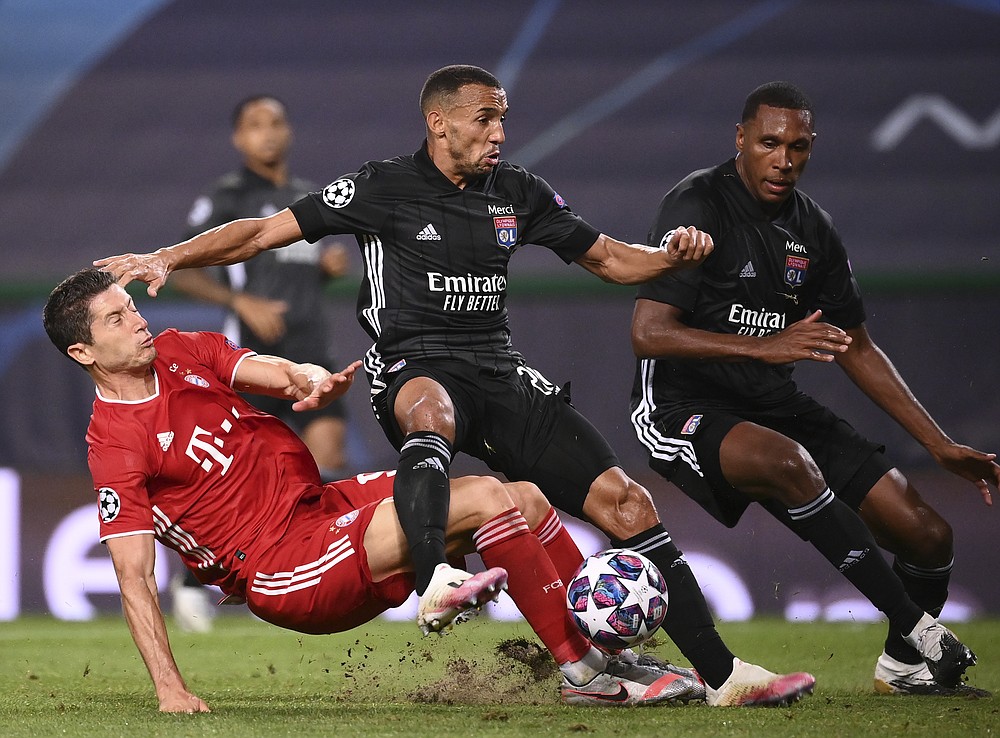 Lyon's Marcal, centre, duels for the ball with Bayern's Robert Lewandowski during the Champions League semifinal soccer match between Lyon and Bayern at the Jose Alvalade stadium in Lisbon, Portugal, Wednesday, Aug. 19, 2020. (Franck Fife/Pool via AP)