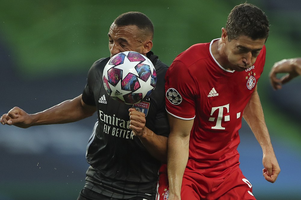 Lyon's Lucas Tousart, left, and Bayern's Robert Lewandowski go for the ball during the Champions League semifinal soccer match between Lyon and Bayern Munich at the Jose Alvalade stadium in Lisbon, Portugal, Wednesday, Aug. 19, 2020. (Miguel A. Lopes/Pool via AP)