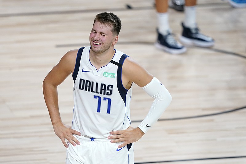 Boban Marjanovic and Luka Doncic of the Dallas Mavericks shake