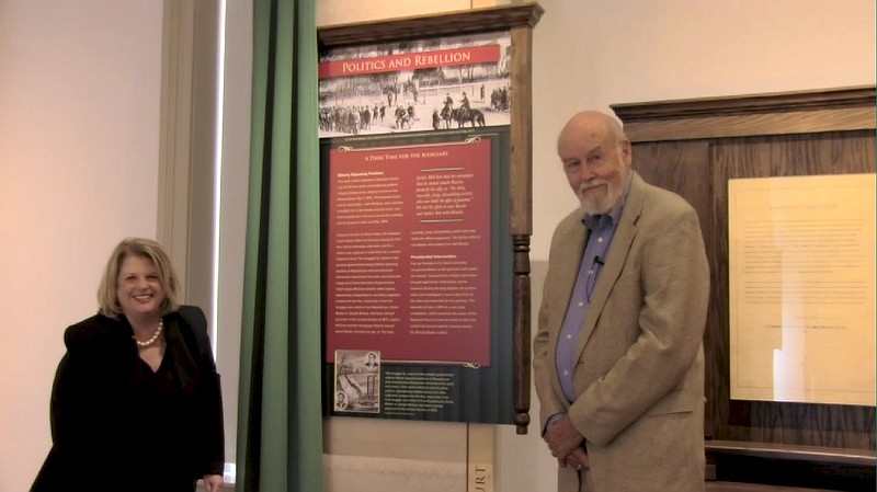 Barbara Webb, justice-elect to the Arkansas Supreme Court, and guest curator Ernie Dumas examine the panels in the new “Arkansas Supreme Court” exhibit at the Old State House Museum.
(Special to the Democrat-Gazette)