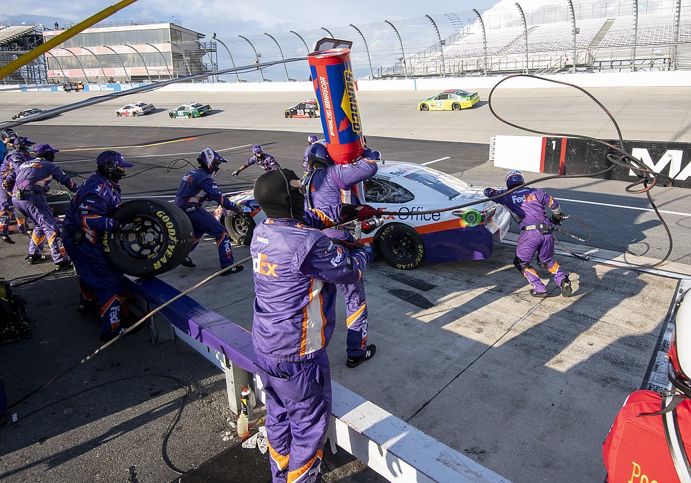 Denny Hamlin (11) pits during a NASCAR Cup Series auto race at Dover International Speedway, Sunday, Aug. 23, 2020, in Dover, Del. (AP Photo/Jason Minto)