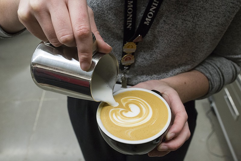 NWA Democrat-Gazette/CHARLIE KAIJO Rainy Bray, director of coffee, creates latte art on Friday, December 1, 2017 at Brightwater in Bentonville. Brightwater and Airship Coffee are partnering to offer specialty coffee certification in the beverage studies at the culinary art school. The program will help meet the demand for skilled workers in the NWA coffee scene as well as train students to be competitive for jobs elsewhere.