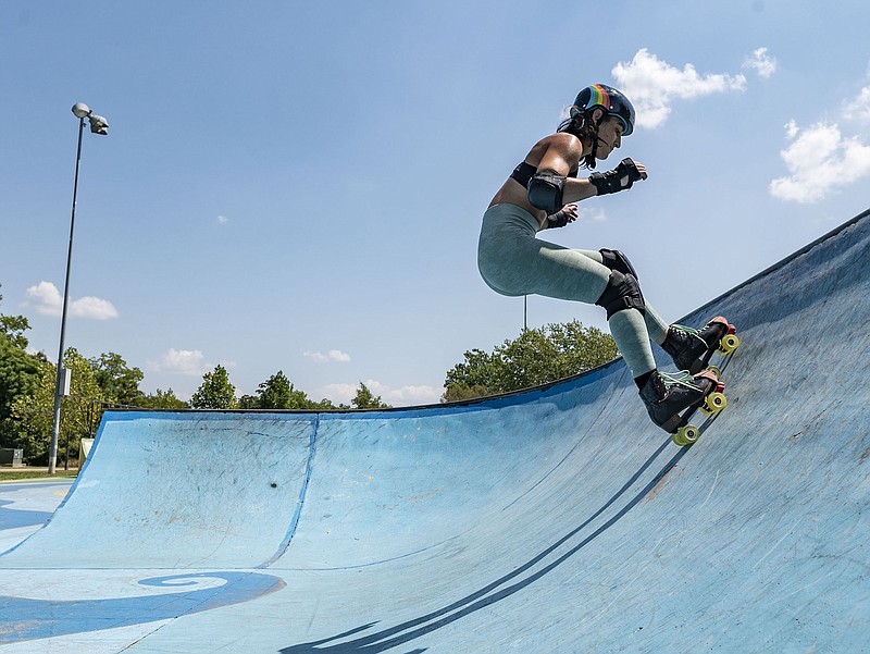 Isabella Di Bari roller skates Monday, August 24, 2020 in the bowl at Memorial Skate Park in Bentonville. Di Bari was with Alan Carbajal, not shown, enjoying what they called their coronavirus activity. Di Bari took up skating in May and Carbajal  took it up in June so they could get out and enjoy the outdoors.  (NWA Democrat-Gazette/Spencer Tirey)