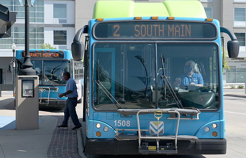 Riders wait to board their bus at the River Cities Transit Center in Little Rock on Tuesday, Aug. 25, 2020. Rock Region Metro board of directors met at noon to consider adopting RIDE 2020, a proposed overhaul of the regular bus ours that will see under-performing routes dropped with resources shifted to more popular routes that will allow more frequent stops and expand weekend service.
(Arkansas Democrat-Gazette/Stephen Swofford)