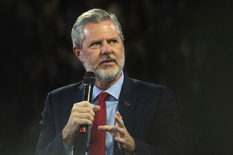 FILE - In this, Nov. 13 2019, file photo, Liberty University President Jerry Falwell Jr. talks to Donald Trump Jr. about his new book "Triggered" during convocation at Liberty University in Lynchburg, Va.  (Emily Elconin/The News & Advance via AP, File)