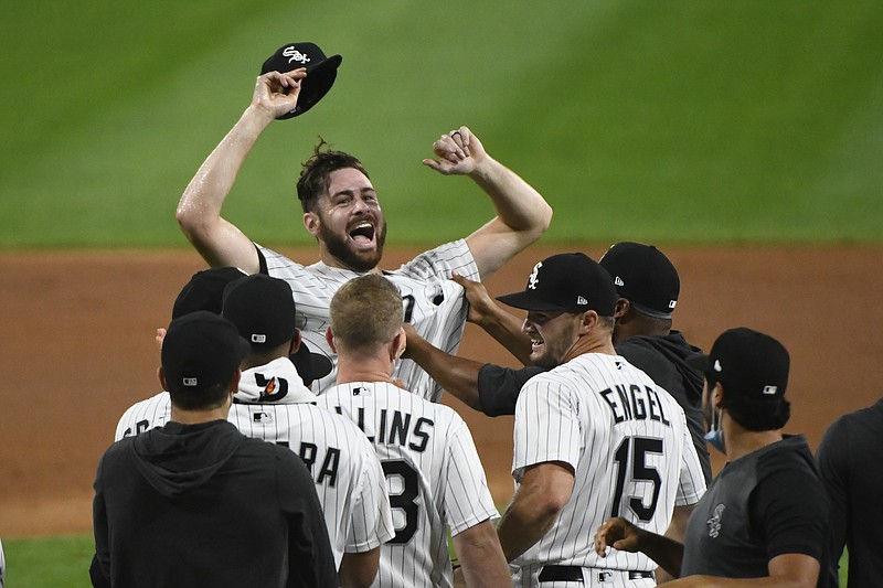 Chicago White Sox starting pitcher Lucas Giolito, facing camera, and teammates celebrate his no-hitter in a baseball game against the Pittsburgh Pirates, Tuesday, Aug. 25, 2020, in Chicago. (AP Photo/Matt Marton)