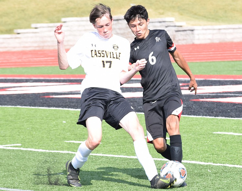 RICK PECK/SPECIAL TO MCDONALD COUNTY PRESS McDonald County's Estaban Martinez battles with a Cassville player for control of the ball during the Mustangs' 0-0 tie with Wildcats in a scrimmage on Aug. 25 at MCHS.