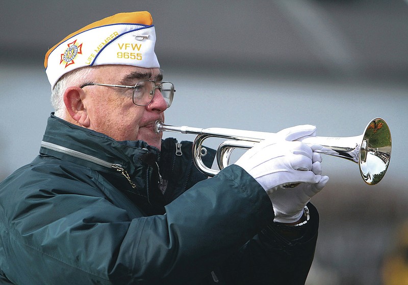 Jim Reynolds with Fox Lake VFW Post 9655 plays the bugle at the Veterans Day ceremony in Fox Lake on Friday, November 11, 2011. Reynolds has been on a mission to play taps wherever and whenever he’s needed as a solemn message of mourning and thanks for military service. He hasn’t kept official track, but he estimates he’s played at more than 1,000 functions. (George LeClaire/Daily Herald via AP)