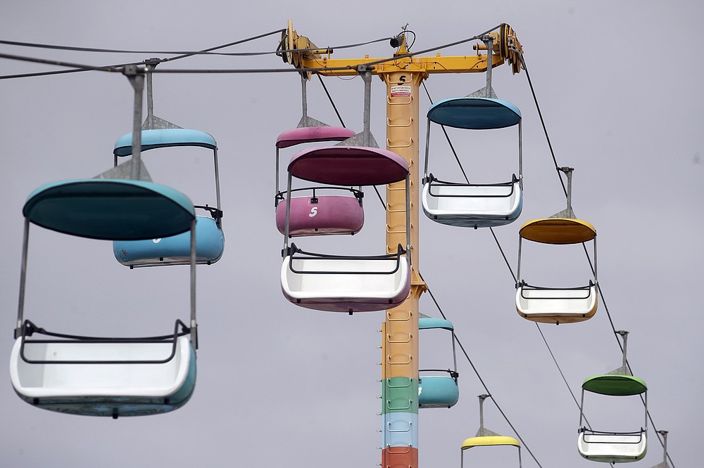Sky gliders are shown empty above the Santa Cruz Beach Boardwalk during the coronavirus outbreak in Santa Cruz, Calif., Thursday, July 2, 2020. The United Nations Secretary-General Antonio Guterres on Tuesday, Aug. 25, 2020, said the global tourism industry has been devastated by the coronavirus pandemic, with $320 billion lost in exports in the first five months of the year and more than 120 million jobs at risk. (AP Photo/Jeff Chiu, File)