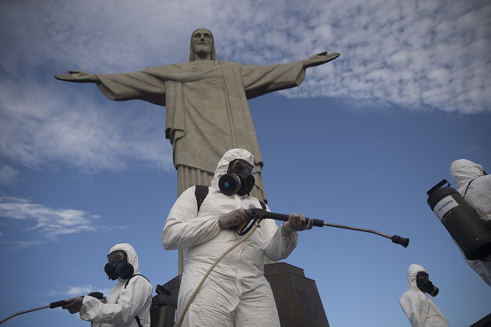 Soldiers disinfect the Christ the Redeemer site, currently closed due to the coronavirus pandemic in Rio de Janeiro, Brazil, Thursday, Aug. 13, 2020. The United Nations Secretary-General Antonio Guterres on Tuesday, Aug. 25, 2020, said the global tourism industry has been devastated by the coronavirus pandemic, with $320 billion lost in exports in the first five months of the year and more than 120 million jobs at risk. (AP Photo/Silvia Izquierdo, File)
